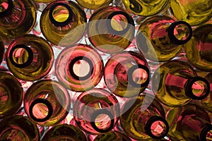 Red glass empty beer bottles lie in rows