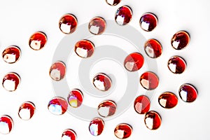 Red glass stones on a white background