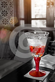 Red Glass Of Water On The Table With Sun Light