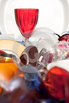 Red glass wine cup and a mass of kitchen utensils