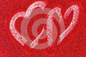Red glitter background with a heart drawn a finger
