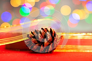 Red glittery decoration in a colorful Christmas composition isolated on background of blurred lights