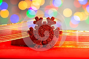 Red glittery decoration in a colorful Christmas composition isolated on background of blurred lights