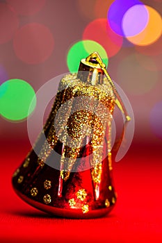 Red glittery decoration in a colorful Christmas composition isolated on background of blurred lights