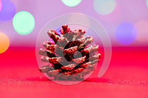 Red glittery decoration in a colorful Christmas composition isolated on background of blurred lights