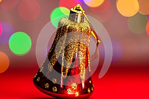 Red glittery decoration in a colorful Christmas composition isolated on background of blurred lights