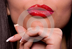 Red gloss lips with kissing gesture.