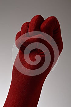 Red glove (hand) clenching fist