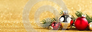 red and gold balls and fir on bokeh background