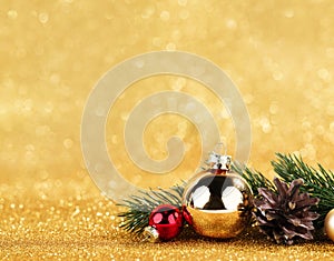 red and gold balls and fir on bokeh background