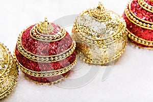 Red and gold Christmas balls in snow, christmas background