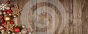 Red and gold Christmas ornament corner border banner, above view on a wood background photo