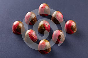 Red and gold colored bonbons on black background