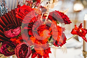 Red gold golden color decor, floral arrangement. Festive bouquet, table decoration. Traditional Chinese New Year party