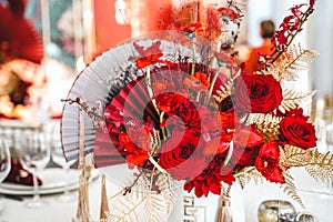 Red gold golden color decor, floral arrangement. Festive bouquet, table decoration. Traditional Chinese New Year party