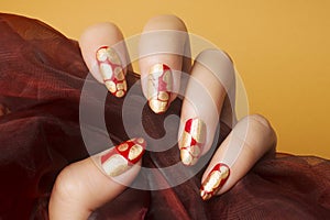 Red gold nails manicure