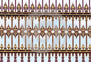 Red and golden casted iron fence background