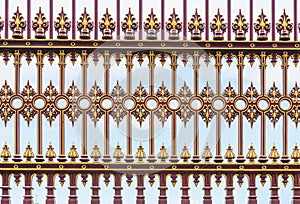 Red and golden casted iron fence background photo