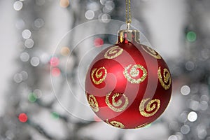 Red golden christmas ball against silvery background