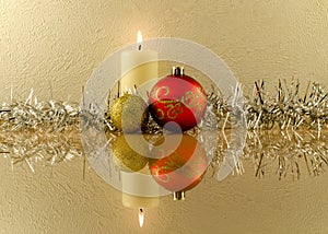 Red and golden Christmas balls on the background of a burning ca