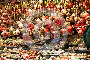 Red and golden christmas tree ornaments and balls, advent market stall close up, photo