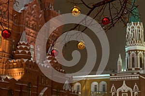 Red golden yellow ball on the tree Christmas decoration on the background of the Kremlin tower of Moscow and the historic