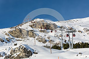 Red gondolas in ski resort Serfaus Fiss Ladis in Austria with sn