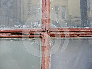 Red Gothic style cross. Christian cross in the window. Abstract cross in church interior
