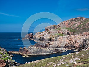 Red granite cliffs on Muckle Roe, Shetland, UK