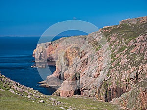 Red granite cliffs on Muckle Roe, Shetland, UK