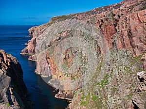 Red granite cliffs on Muckle Roe, Shetland, UK