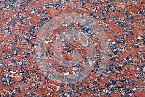 Red granite stone texture. Natural stone red granite . Bright hard texture of red granite. The surface of granite. Facing material
