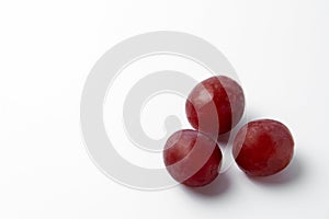 Red grape berries on a white background close-up