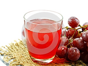 Red grape juice with fruit isolated on white background