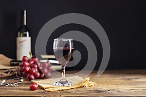 Red grape juice in a glass placed on a wooden table or red wine, a delicious natural healthy juice drink. With a bunch of fresh