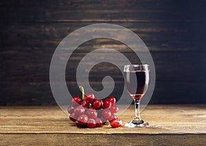 Red grape juice in a glass placed on a wooden table or red wine, a delicious natural healthy juice drink. With a bunch of fresh