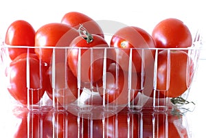 Red grape tomatoes packaged & reflecting. 0590