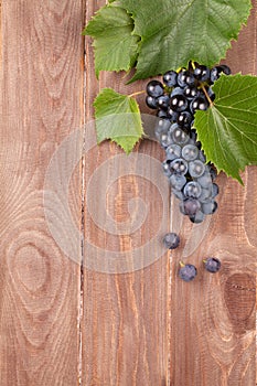 Red grape on wooden table