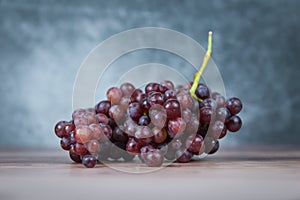 Red grape on wooden table - Bunch of grapes juicy fruit on light and dark background