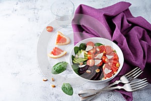 Red grapefruit beet spinach tomato salad in a bowl