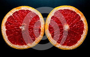 red grapefruit on black background