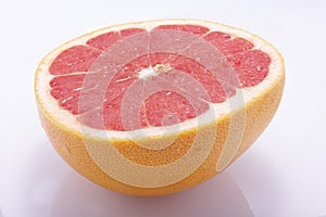Red grapefruit, cut in half, fresh natural, juicy fruit on a white background
