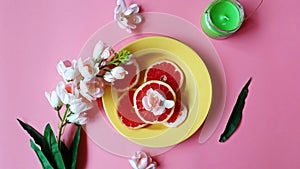 Red grapefruit slices Colorful dishes plate yellow cup on pink background still life banner background illustration Red