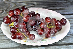 Red grapes, a fruit, botanically a berry of the deciduous woody vines of the flowering plant genus Vitis. Grapes are a non-