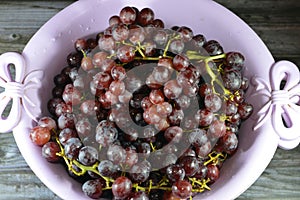 Red grapes, a fruit, botanically a berry of the deciduous woody vines of the flowering plant genus Vitis. Grapes are a non-
