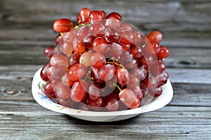 Red grapes, a fruit, botanically a berry of the deciduous woody vines of the flowering plant genus Vitis. Grapes are a non-