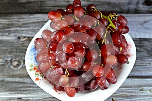 Red grapes, a fruit, botanically a berry of the deciduous woody vines of the flowering plant genus Vitis. Grapes are a non-