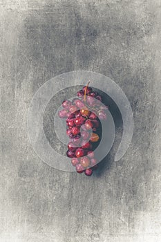 Red grapes on a grey stone background