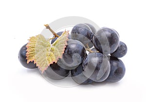 Red grapes with leaves isolated on white background