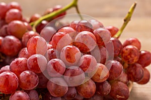 Red grapes on old wooden table,closeup background